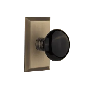 Studio Short Plate with Black Porcelain Knob in Antique Brass